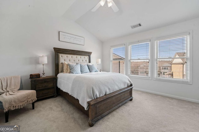 bedroom featuring lofted ceiling, baseboards, visible vents, and light colored carpet