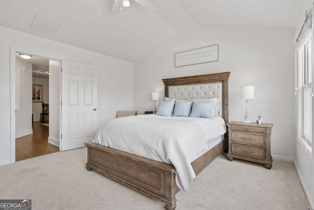 carpeted bedroom featuring attic access, vaulted ceiling, baseboards, and a ceiling fan