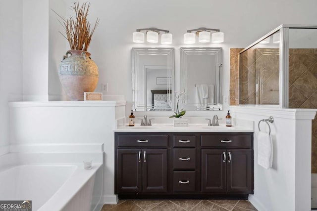 full bathroom with double vanity, a sink, a shower stall, and a bath