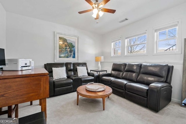 carpeted living area featuring visible vents and ceiling fan