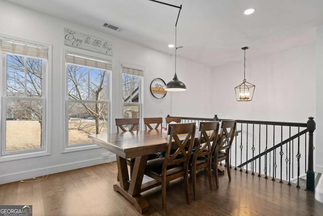 dining room with a notable chandelier, recessed lighting, visible vents, wood finished floors, and baseboards