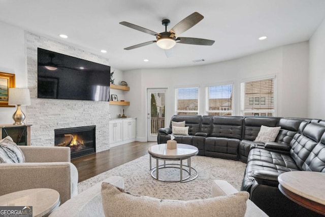 living area with visible vents, ceiling fan, wood finished floors, a fireplace, and recessed lighting