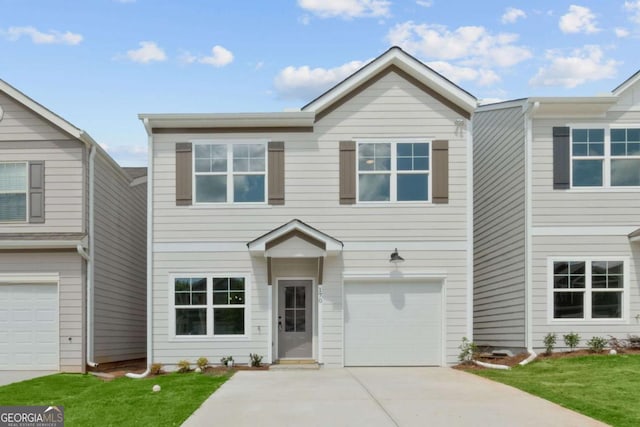 view of front facade featuring driveway, a garage, and a front yard