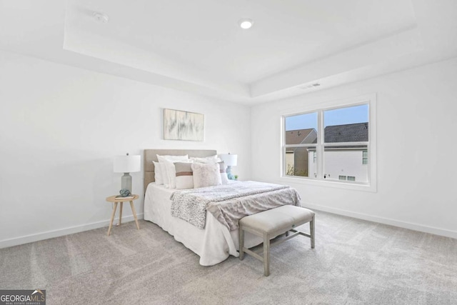 bedroom with carpet floors, recessed lighting, a raised ceiling, visible vents, and baseboards