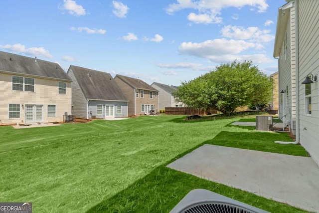 view of yard featuring a patio, central AC unit, and fence