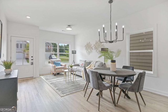 dining area with a notable chandelier, recessed lighting, visible vents, light wood-style floors, and baseboards