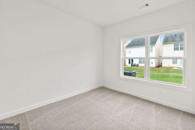 carpeted empty room with visible vents and baseboards