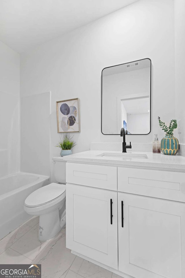 bathroom featuring marble finish floor, vanity, and toilet