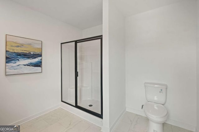 full bathroom with marble finish floor, a shower stall, toilet, and baseboards