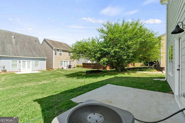 view of yard featuring a patio, fence, and central AC unit