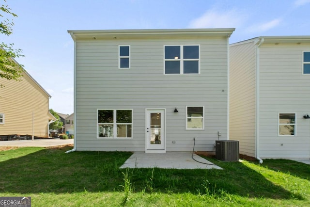 back of house featuring a lawn, central AC, and a patio