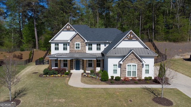 6650 Canyon Cv, Cumming, GA 30028 - craftsman inspired home with stone siding, a standing seam roof, metal roof, and covered porch