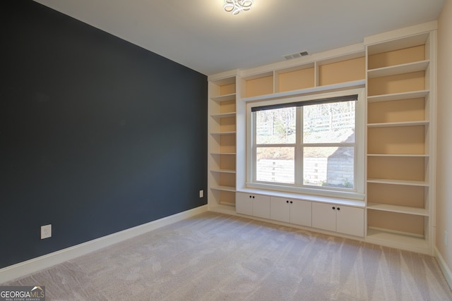 6650 Canyon Cv, Cumming, GA 30028 - spare room with baseboards, light carpet, and built in features