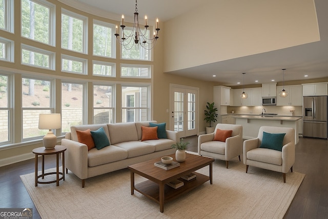 6650 Canyon Cv, Cumming, GA 30028 - living room featuring healthy amount of natural light, wood finished floors, a high ceiling, recessed lighting, and baseboards