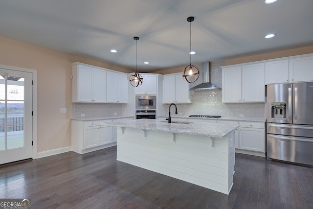 6650 Canyon Cv, Cumming, GA 30028 - kitchen with stainless steel appliances, wall chimney exhaust hood, a sink, white cabinetry, and recessed lighting