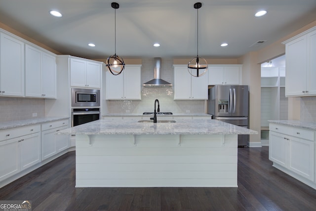 6650 Canyon Cv, Cumming, GA 30028 - kitchen featuring wall chimney exhaust hood, appliances with stainless steel finishes, backsplash, white cabinets, and a sink