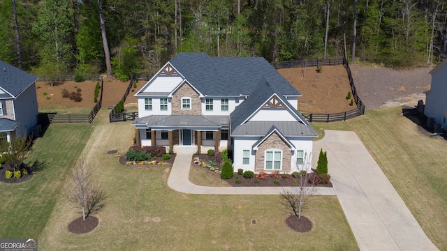 6650 Canyon Cv, Cumming, GA 30028 - craftsman-style home featuring a standing seam roof, stone siding, concrete driveway, a porch, and metal roof