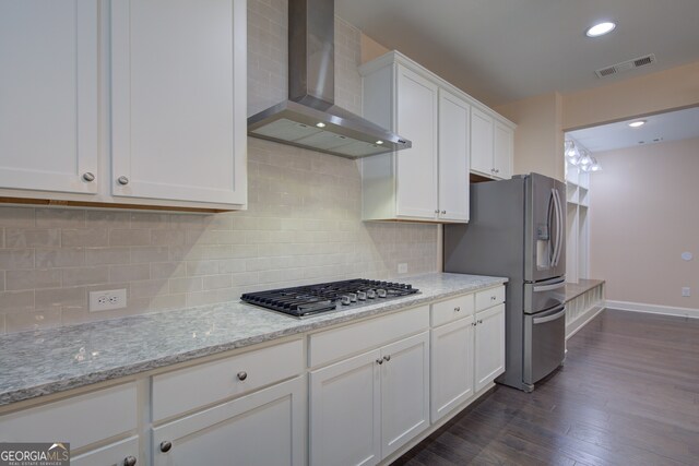 6650 Canyon Cv, Cumming, GA 30028 - kitchen featuring wall chimney range hood, stainless steel appliances, white cabinets, dark wood finished floors, and baseboards