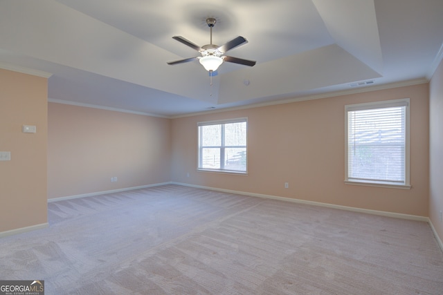 6650 Canyon Cv, Cumming, GA 30028 - spare room with a tray ceiling, crown molding, light carpet, and a ceiling fan