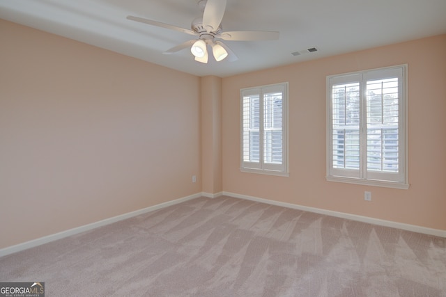 6650 Canyon Cv, Cumming, GA 30028 - spare room with light carpet, baseboards, and a ceiling fan