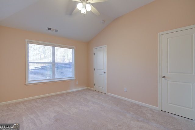 6650 Canyon Cv, Cumming, GA 30028 - unfurnished bedroom featuring vaulted ceiling, light colored carpet, baseboards, and ceiling fan