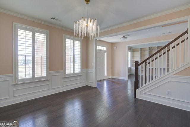 6650 Canyon Cv, Cumming, GA 30028 - entrance foyer with a chandelier, stairs, wainscoting, crown molding, and dark wood-type flooring