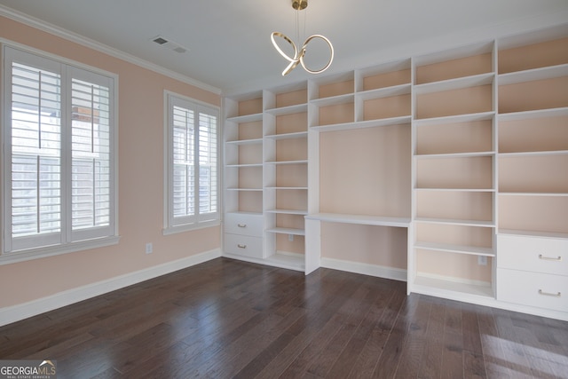 6650 Canyon Cv, Cumming, GA 30028 - empty room with dark wood finished floors, ornamental molding, baseboards, built in features, and a chandelier
