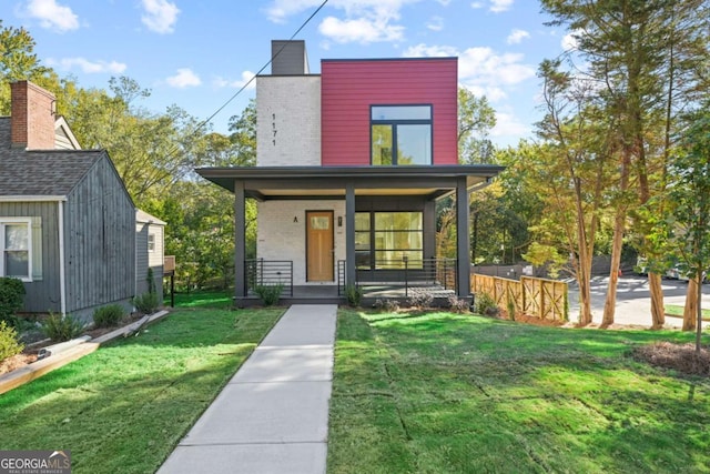 view of front of home featuring a porch, brick siding, and a front lawn