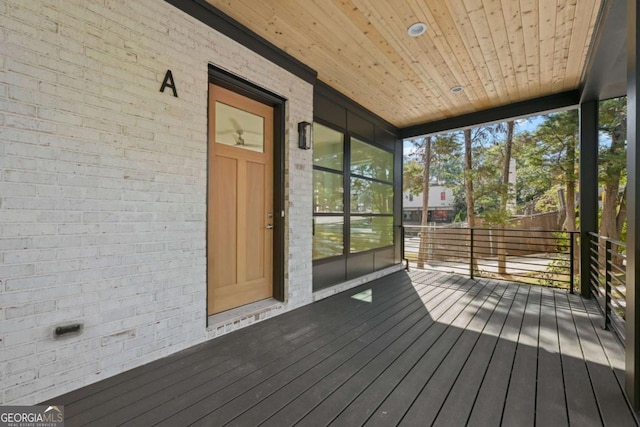 unfurnished sunroom with wood ceiling