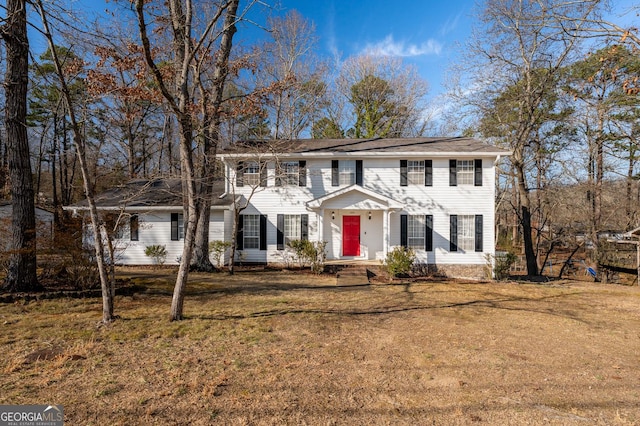 colonial-style house with a front lawn