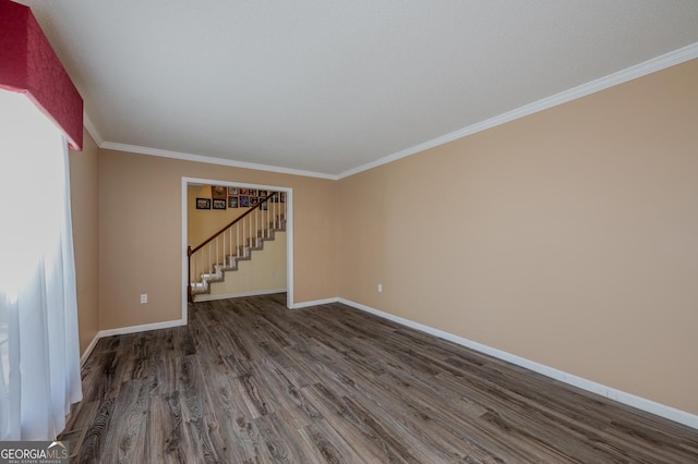 unfurnished room with baseboards, stairway, and wood finished floors