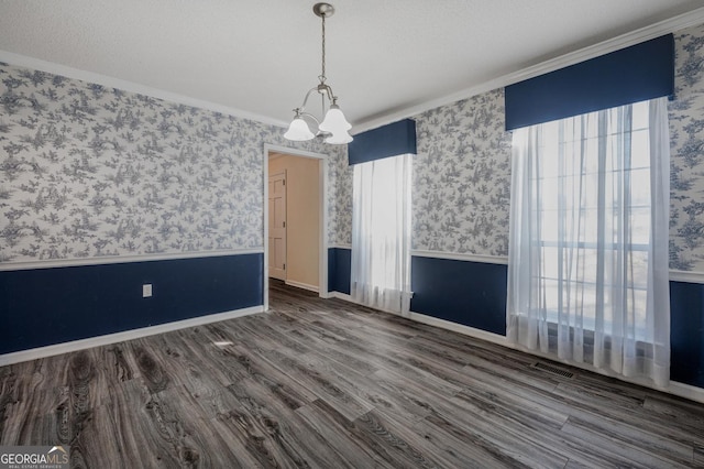 interior space featuring wallpapered walls, a wainscoted wall, and wood finished floors