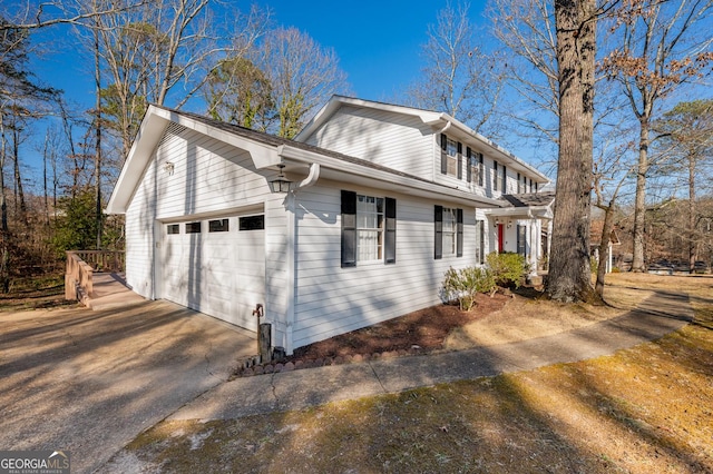 view of home's exterior featuring a garage and driveway