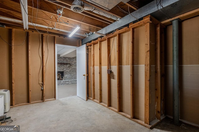 unfinished basement with brick wall and visible vents