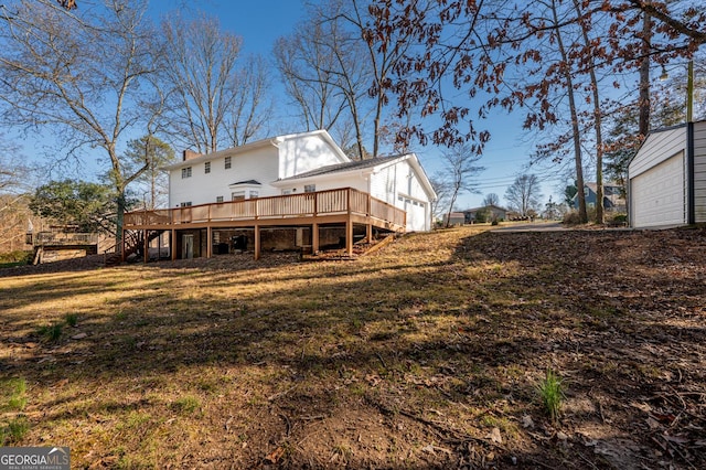 back of property with a yard, a chimney, stairway, a deck, and a garage