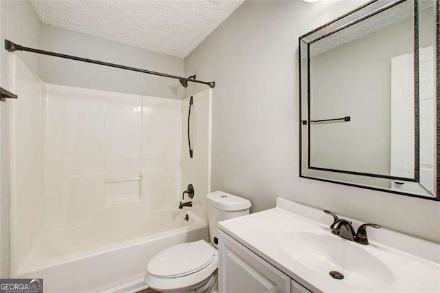 bathroom with toilet, shower / bath combination, a textured ceiling, and vanity