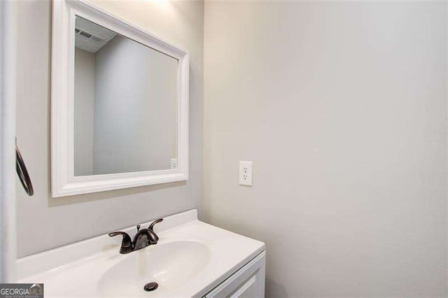 bathroom with vanity and visible vents