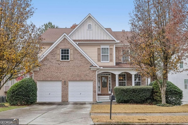 view of front of home featuring driveway, central AC unit, an attached garage, board and batten siding, and brick siding