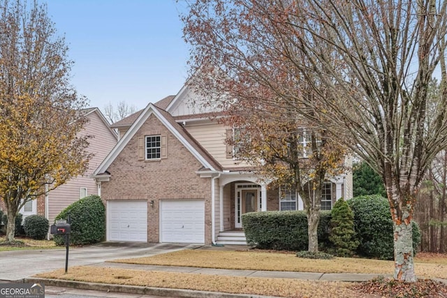 view of front of house with a garage, driveway, and brick siding