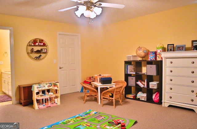 recreation room featuring ceiling fan and carpet flooring