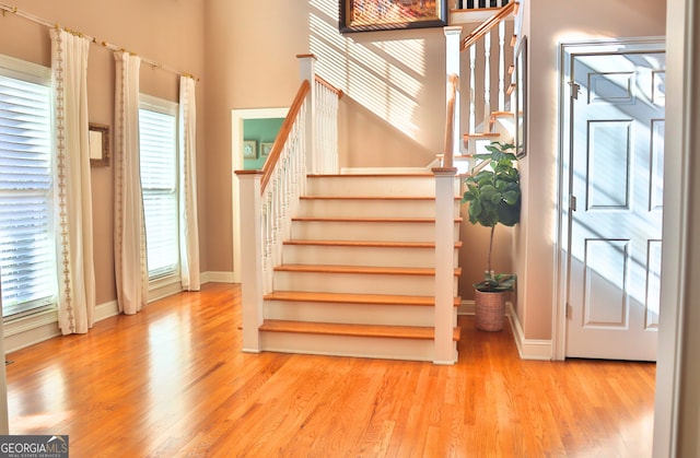 stairway featuring baseboards and wood finished floors