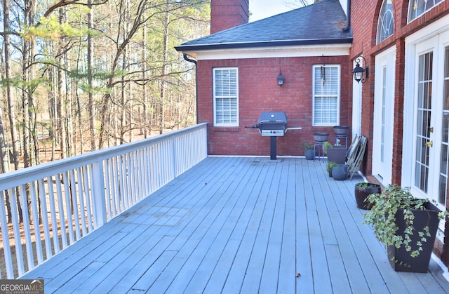 wooden terrace featuring area for grilling