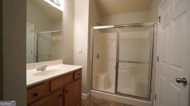 full bathroom with a shower stall and vanity