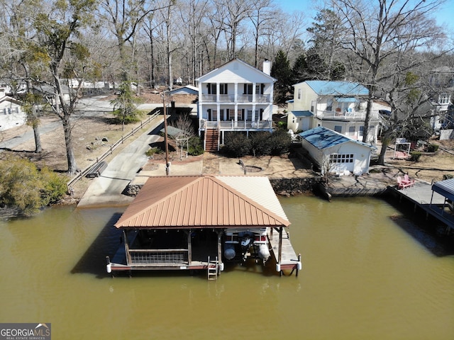 view of dock with a water view, boat lift, and stairway