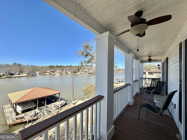 balcony featuring a water view and ceiling fan