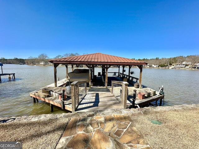 dock area with a water view and boat lift