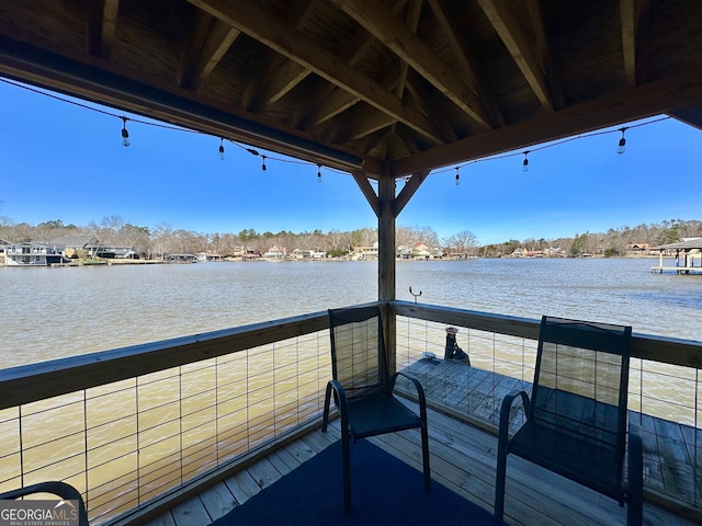 dock area with a water view and a balcony