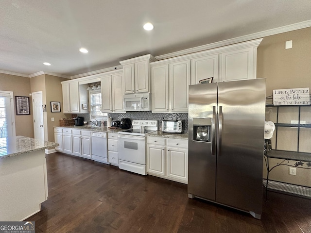 kitchen with ornamental molding, white appliances, and dark wood finished floors