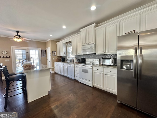 kitchen with ornamental molding, white appliances, backsplash, and dark wood-style floors