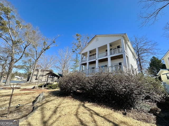 exterior space with ceiling fan and a balcony